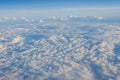 Clouds and blue sky view out from window of airplane fying over earth ground. Royalty Free Stock Photo