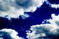 Clouds in bright dark blue sky