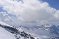 Clouds casting shadows on snowy mountain range