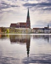 Clouds and cathedral in the old town of Schwerin are reflected in the lake Pfaffenteich Royalty Free Stock Photo