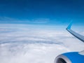 Clouds,clear bright blue sky, engine and wing of plane. Aerial view from plane illuminator Royalty Free Stock Photo