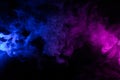 Clouds of colorful swirling blue and pink smoke dark background