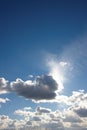 Clouds. Copyspace scenic view of a blue cloudy sky with sun shining through. Low landscape view of a cumulus cloud Royalty Free Stock Photo