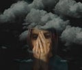 Clouds, dark ones, surround a depressed woman