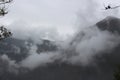 Clouds descending upon the mountain peaks of the Andes on an overcast day, the Vilcabamba range in Peru