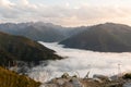 Clouds drifting among mountains down in a valley Royalty Free Stock Photo