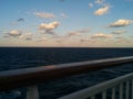 Clouds at dusk at sea from cruise ship railing Royalty Free Stock Photo