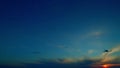 Clouds fading away during sunset. Moon at evening sunset in purple clouds. Halo is an optical phenomenon. Time lapse.