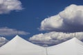 Clouds float over the tops of a white in blue sky Royalty Free Stock Photo