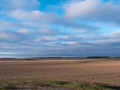 Clouds floating over a field with crops at dawn Royalty Free Stock Photo