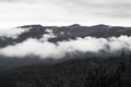 Clouds floating over the mountains. Black and white image Royalty Free Stock Photo