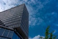 Clouds fly across a blue sky over a glass windowed building at B Royalty Free Stock Photo