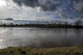 Clouds flying over a large river and tree-line on the shore Royalty Free Stock Photo