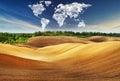 Clouds in the form of a map of the world over the field. Travel and landscape concept Royalty Free Stock Photo