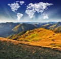 Clouds in the form of a map of the world over the mountains. autumn dawn in the Carpathians