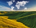 Clouds in the form of a world map over a green field. Travel and landscape concept Royalty Free Stock Photo