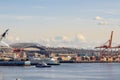 Clouds forming and moving in front of Mt. Rainier and part of the harbor island with containers in the Elliott Bay in Seattle,