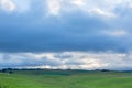 Clouds gathering over green pastures Royalty Free Stock Photo