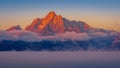 Clouds hanging over Jackson Lake as the sun rises and lights up the tallest peaks of Grand Teton National Park Royalty Free Stock Photo