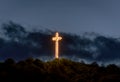 clouds and illuminated cross in the evening at sunset 01