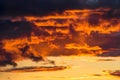 Clouds illuminated at sunset by fiery yellow sunlight