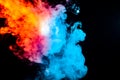 Clouds of colored smoke: blue, red, orange, pink; scrolling on a black background Royalty Free Stock Photo