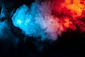 Clouds of isolated colored smoke: blue, red, orange, pink; scrolling on a black background in the dark Royalty Free Stock Photo