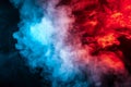 Clouds of isolated colored smoke: blue, red, orange, pink; scrolling on a black background in the dark