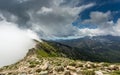 Clouds meet the top of a mountain ridge on GR20 in Corsica