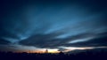Clouds in motion at sunset over the city. Sunset over the city. Royalty Free Stock Photo