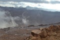 Consecutive mountain chains, under subtle clouds, close up peak