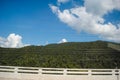 Clouds on the mountains have a clear sky on the side of the road Royalty Free Stock Photo