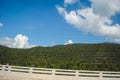 Clouds on the mountains have a clear sky on the side of the road Royalty Free Stock Photo