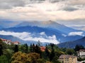 Clouds in mountains, houses with colorful roofs. Rosa Khutor, Sochi, Russia