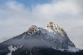 Clouds move around snowy and rocky mountain peaks Gehrenspitze