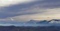 Clouds muffled above the snow-capped peaks of the Apennine mountains