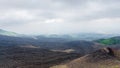 Clouds over black lava field on Mount Etna Royalty Free Stock Photo