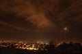 clouds over the city in the middle of the night Royalty Free Stock Photo