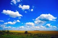 Clouds over the field . Summer landscape. Royalty Free Stock Photo