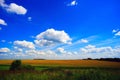 Clouds over the field . Summer landscape. Royalty Free Stock Photo