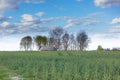 Clouds over the fields. Green field, wooden house on the horizon. Village landscape. Royalty Free Stock Photo