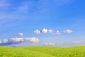 Clouds over green, grassy hills. Rural landscape.