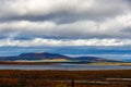 Clouds over the lake in the mountainous part of the tundra in autumn