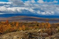 Clouds over the lake in the mountainous part of the tundra in autumn