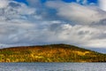 Clouds over the lake in the mountainous part of the tundra in autumn