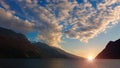 Clouds over mountain lake at dawn, sunrise over beautiful mountain lake Royalty Free Stock Photo