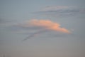 An intriguing cloud formation forms above the ocean shorline