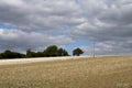 Clouds over recently tilled farmland