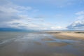 Clouds over the sandy beach of Ouistreham in Europe, France, Normandy, in summer, on a sunny day Royalty Free Stock Photo