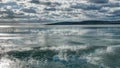 Clouds over the semi-frozen lake